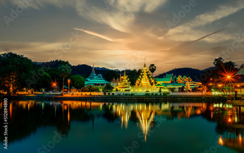 Dramatic sunset over Thai Buddhist temple at Mae Hong Orn, Thailand.