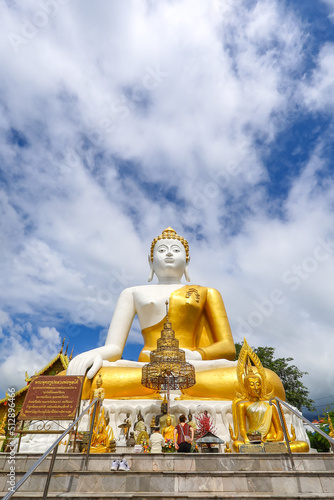 Mae Hia,Chiang Mai,Northern Thailand on Septemmber 13,2019:Sitting Buddha Statue at Wat Phra That Doi Kham. © mickey_41