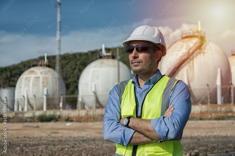 worker with helmet. engineer at work. person in helmet using radio comunication. person in helmet with oil tanks in the desert onbackground.
worker with helmet. engineer at work. person in helmet using radio comunication. person in helmet with oil tanks in the desert onbackground.