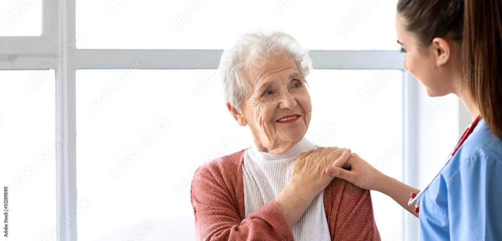 Medical worker with senior woman in nursing home Medical worker with senior woman in nursing home