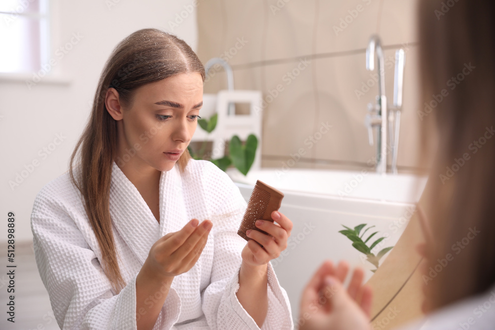 Young woman with problem of dandruff in bathroom Young woman with problem of dandruff in bathroom