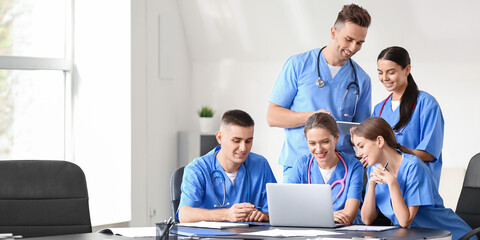 Group of students with laptop and tablet computer at medical university