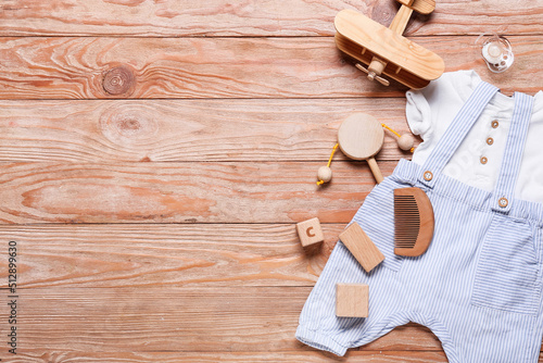 Baby boy clothes and different accessories on wooden background