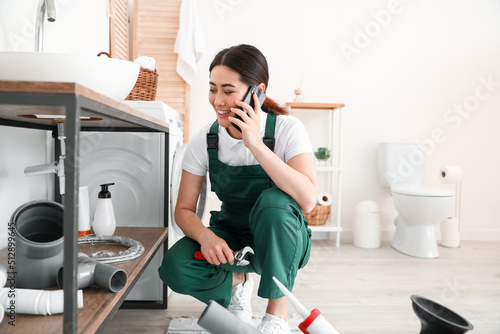 Asian female plumber with w...