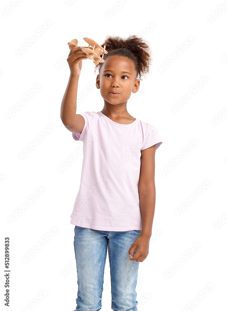 Little African-American girl with wooden airplane on white background Little African-American girl with wooden airplane on white background