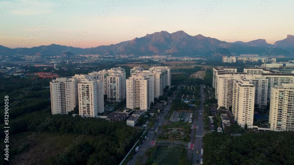Aerial view of Jacarépagua in Rio de Janeiro, Brazil. Residential buildings and mountains in the background. Sunny day. Sunset. Drone take. Aerial view of Jacarépagua in Rio de Janeiro, Brazil. Residential buildings and mountains in the background. Sunny day. Sunset. Drone take.