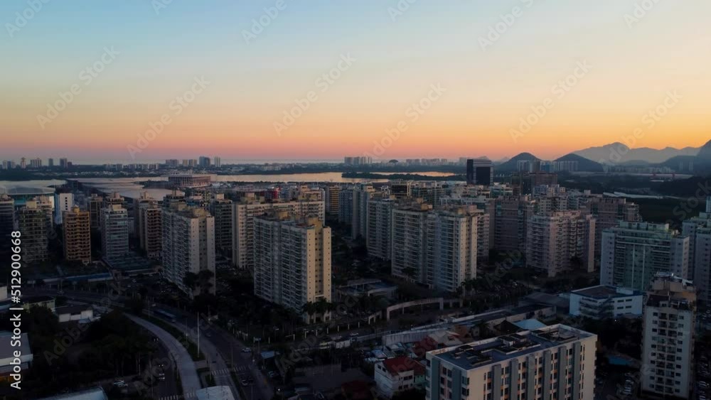 Aerial view of Jacarépagua lagoon in Rio de Janeiro, Brazil. Residential buildings and mountains around the lake. Barra da Tijuca beach in the background. Sunny day. Sunset. Drone take. Aerial view of Jacarépagua lagoon in Rio de Janeiro, Brazil. Residential buildings and mountains around the lake. Barra da Tijuca beach in the background. Sunny day. Sunset. Drone take.