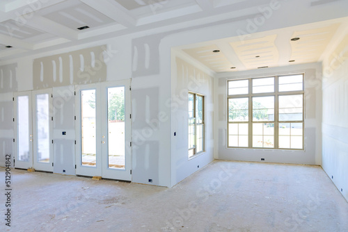 Принти на полотні In preparation for painting a newly house, finishing putty is being applied to a