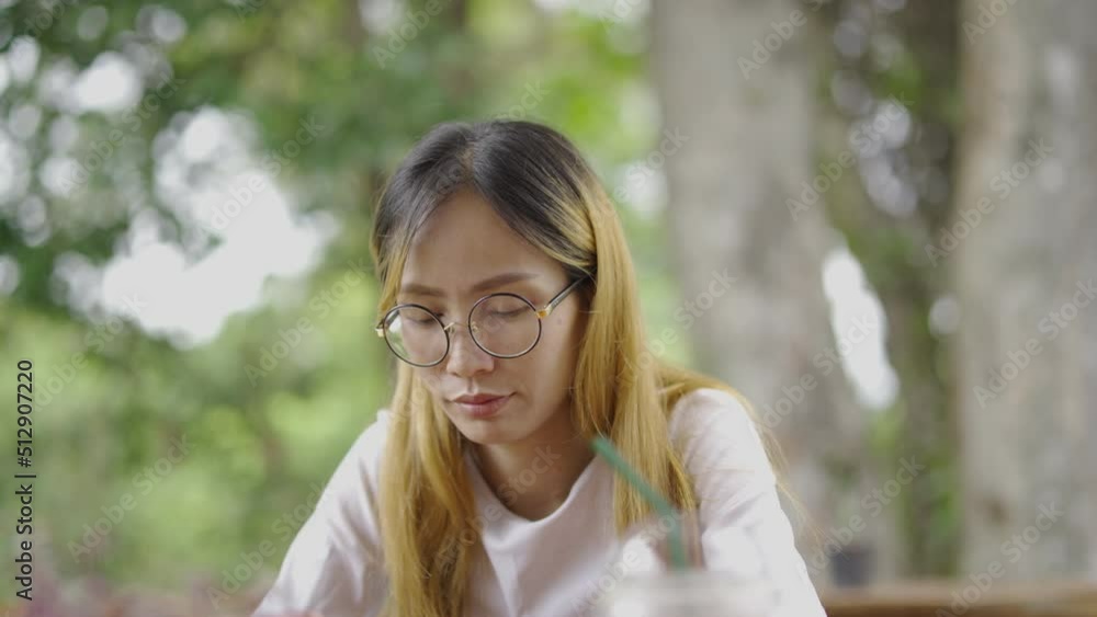 Asian girl ware mask protect virus using smartphone in cafe texting sharing messages on social media enjoying mobile technology relaxing in coffee shop. Asian girl ware mask protect virus using smartphone in cafe texting sharing messages on social media enjoying mobile technology relaxing in coffee shop.