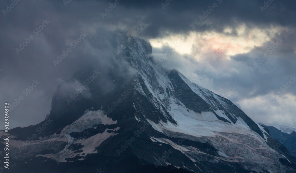 Beautiful evening light and storm cloudscape in the Swiss Alps