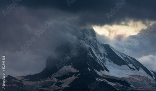 Beautiful evening light and storm cloudscape in the Swiss Alps © Calin Tatu
