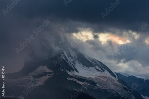 Beautiful evening light and storm cloudscape in the Swiss Alps © Calin Tatu