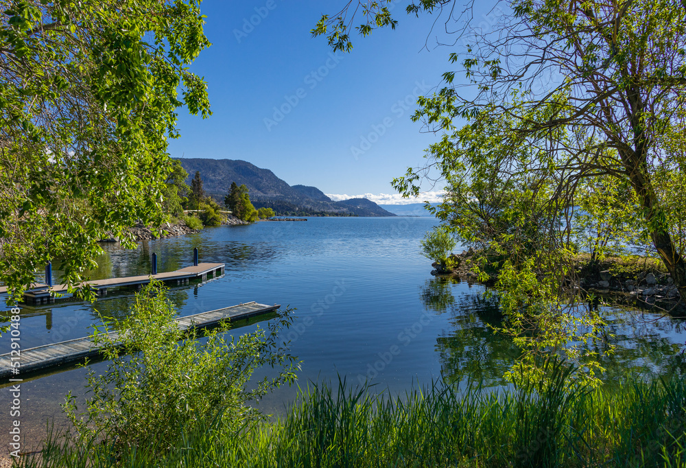Wooden dock on a calm lake on beautiful summer morning, Okanagan Lake, Canada. Wooden dock on a calm lake on beautiful summer morning, Okanagan Lake, Canada.
