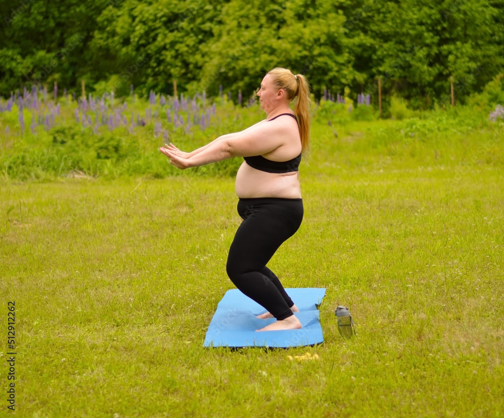 Portrait of happiness plus size woman practicing yoga on outdoors.