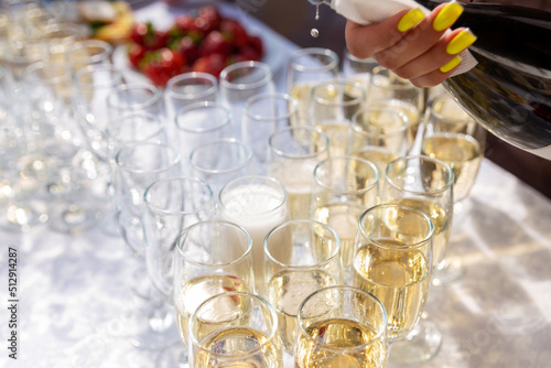 A banquet table with wine glasses and plates with strawberries. © BY-_-BY