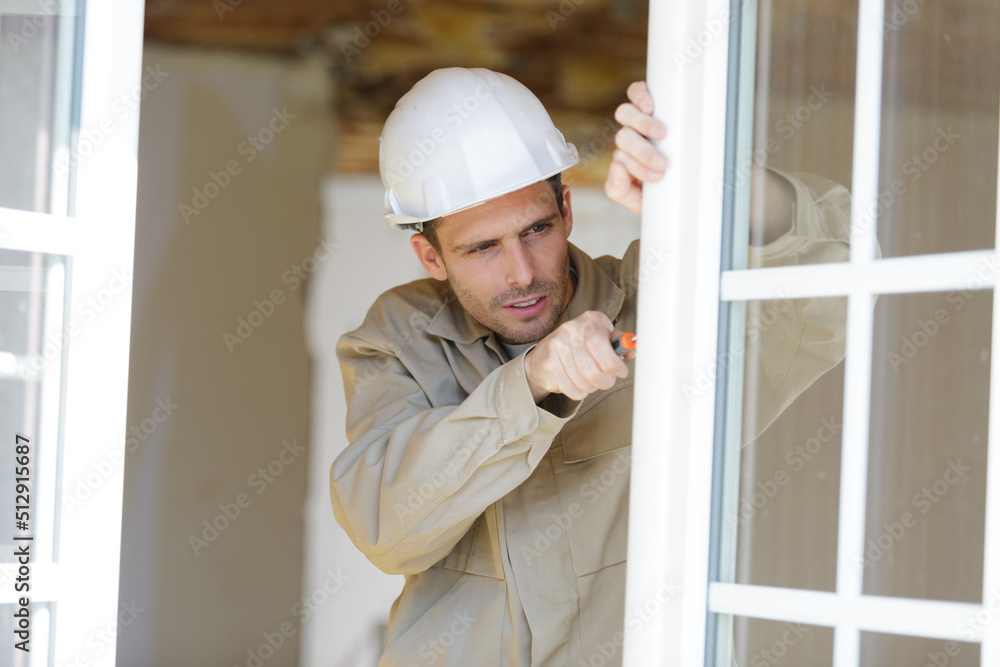 worker installing plastic window handle worker installing plastic window handle