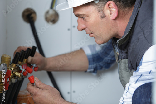 a professional plumber fixing pipes © auremar
