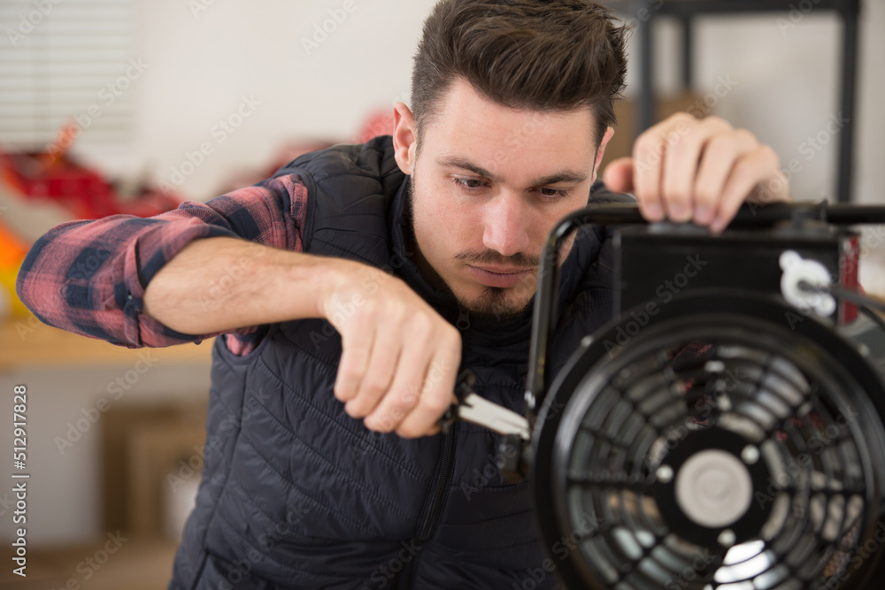 close-up of a male repairman fixing radiator close-up of a male repairman fixing radiator