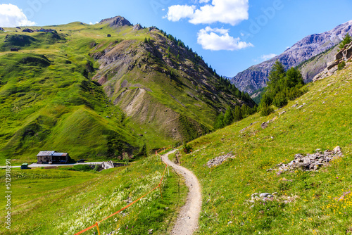 Hiking and mtb bike trial in beautiful Alpisella valley on sunny summer day, Alps Mountains, Italy