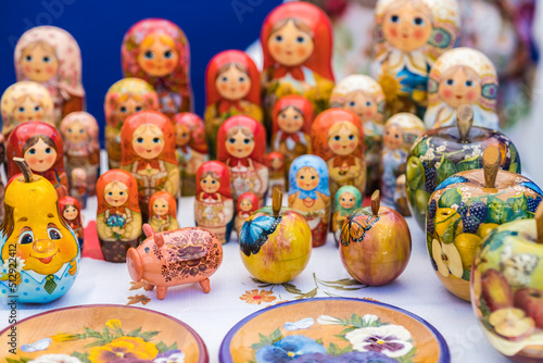 A brightly colored set of wooden dolls and other figures laying dolls. Traditional handmade toys and souvenirs. 