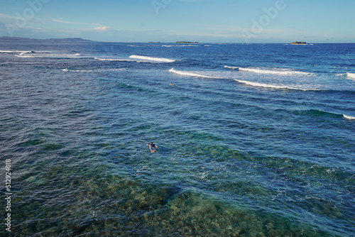 It's time for surfing! Young man swimming on a surf board.