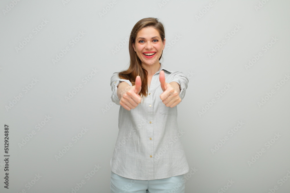 Thumb up. Smiling woman, isolated female portrait, young lady dressed pants and gray shirt. Thumb up. Smiling woman, isolated female portrait, young lady dressed pants and gray shirt.