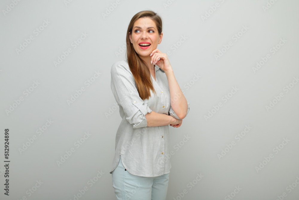 Thinking woman looking up isolated portrait, young lady dressed pants and gray shirt. Thinking woman looking up isolated portrait, young lady dressed pants and gray shirt.