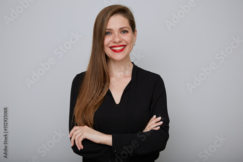 Smiling business woman in black shirt standing with arms crossed, isolated female portrait.