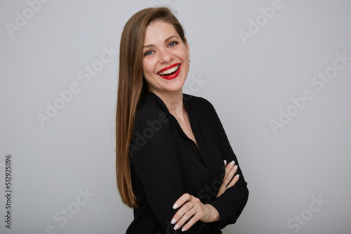 Smiling business woman in black shirt standing with arms crossed, isolated female portrait. photo