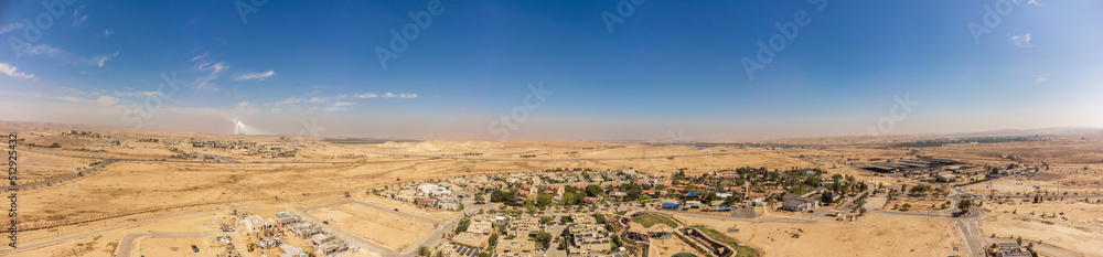 Wide panorama from the sky over the roofs Tlalim village of Negev desert