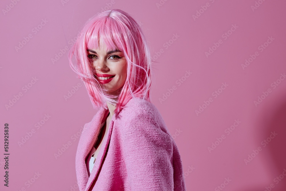 Young woman pink jacket holding hair cosmetics studio model unaltered Young woman pink jacket holding hair cosmetics studio model unaltered