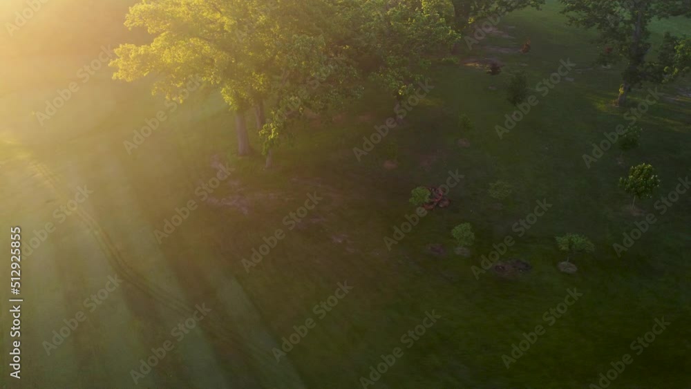 Tranquil Aerial Shot Of Mowing Lawn In Countryside At Sunset With Sun Light Tranquil Aerial Shot Of Mowing Lawn In Countryside At Sunset With Sun Light