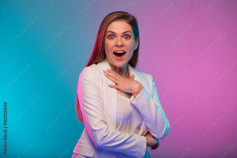 Amazed emotional business woman with hand near face, portrait with neon lights colors effect. Female model on neon colored background wearing white suit. Amazed emotional business woman with hand near face, portrait with neon lights colors effect. Female model on neon colored background wearing white suit.