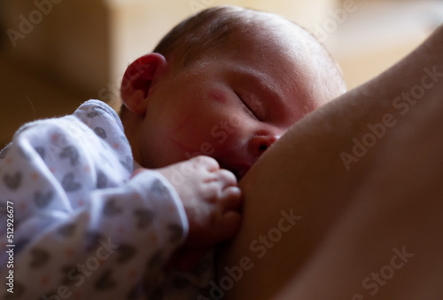 an adorable newborn baby breastfeeding
