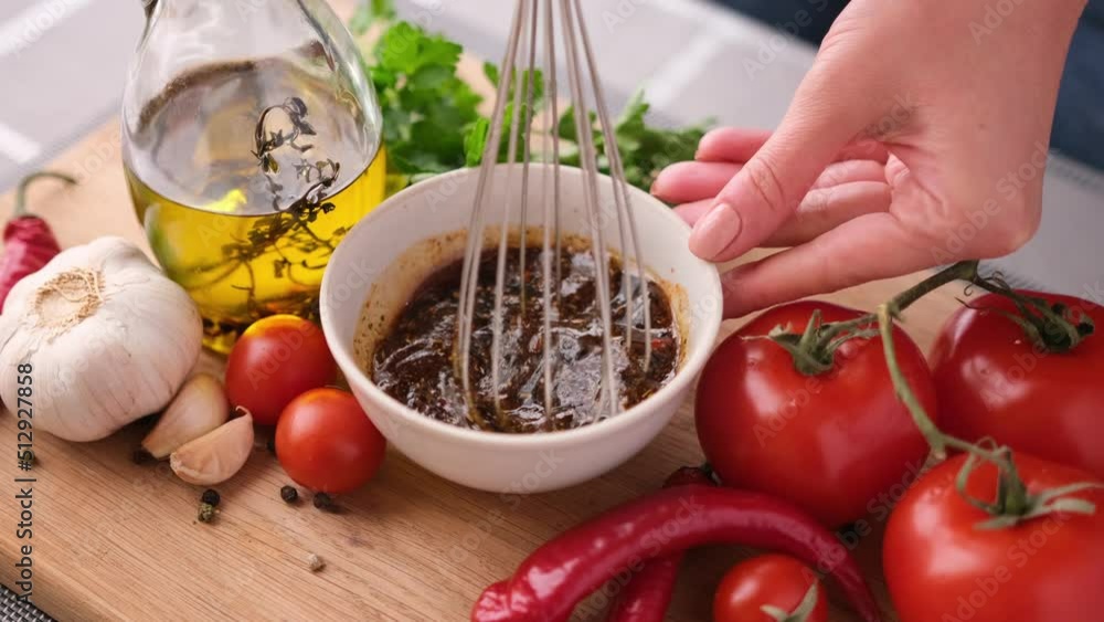Making chicken marinade for Caesar salad - mixing salt, spices and olive oil in ceramic bowl Making chicken marinade for Caesar salad - mixing salt, spices and olive oil in ceramic bowl