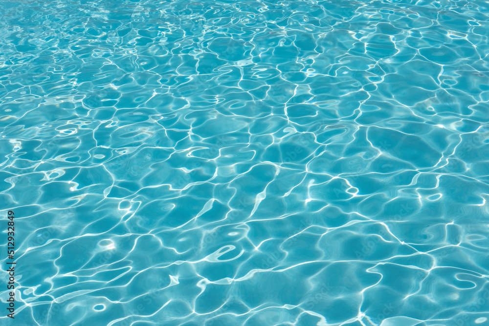 Swimming pool water ripples background, clean blue seiche waves in a spacious outdoor piscina, concept for summer vacation mood, tropical or hot destination holidays or traveling to an exotic location