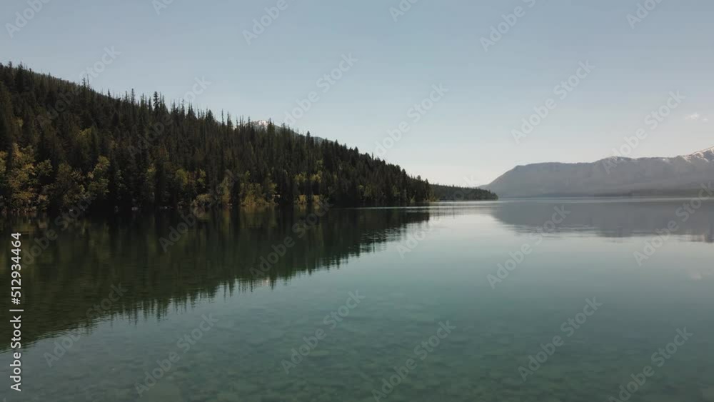 cinematic Lake Mcdonald flying low on top of the lake, national forest and mountains cinematic Lake Mcdonald flying low on top of the lake, national forest and mountains