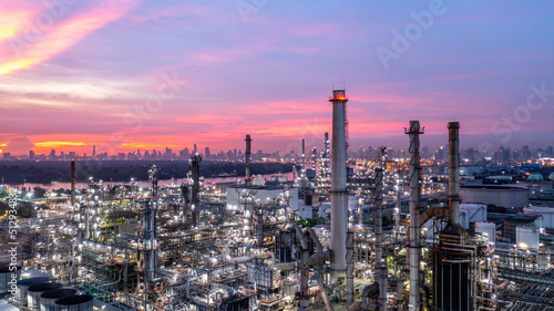 Oil and gas refinery plant form industry zone at night, Aerial view oil and gas Industrial petrochemical fuel power and energy.