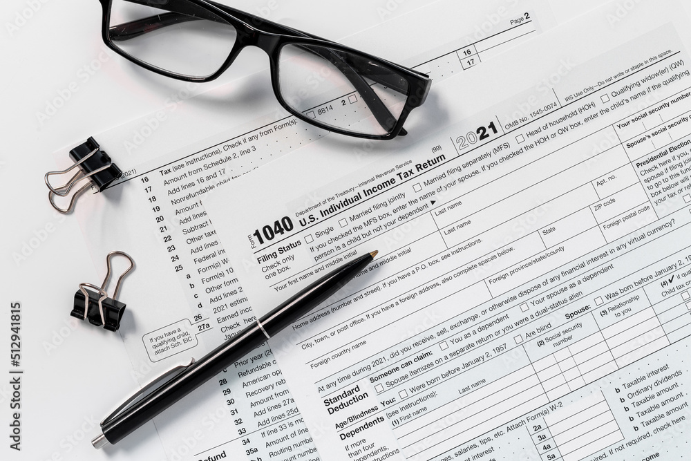 Pen on US individual tax form. Tax payment season Pen on US individual tax form. Tax payment season