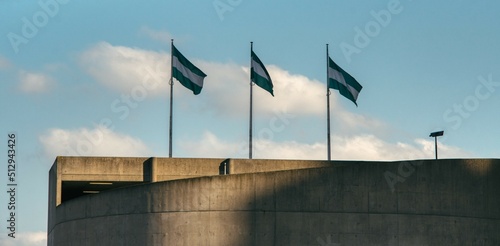 Three flags with the colors of Rotterdam, waving in the wind of The Netherlands' second largest city photo