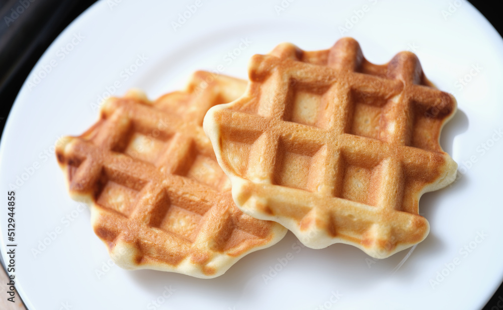 Fresh delicious homemade waffles on white plate Fresh delicious homemade waffles on white plate