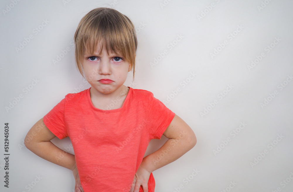 Dissatisfied girl with blond hair on a white background with copy   year old girl with an evil look in a pink  of family problems,  raising children, conflicts Stock Photo |