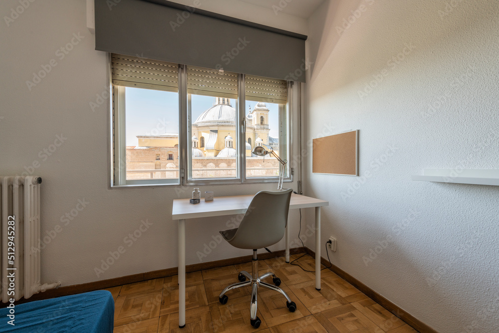 Simple wood plank study table with swivel chair and large window with good view Simple wood plank study table with swivel chair and large window with good view