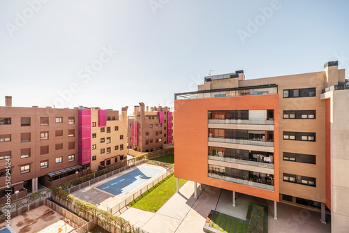Interior facades of interior common areas with artificial grass floor and covered swimming pool in urban residential development