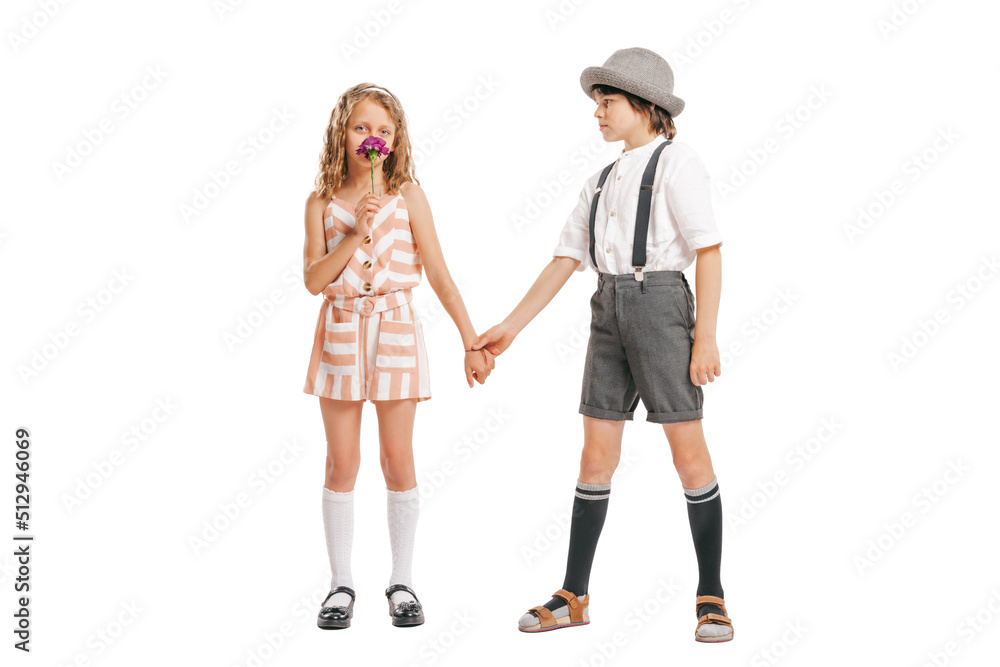 Portrait of little boy and girl, charming kids retro style outfit, fashion of 70s, 80s years isolated on white studio background with copy space for ad. Portrait of little boy and girl, charming kids retro style outfit, fashion of 70s, 80s years isolated on white studio background with copy space for ad.