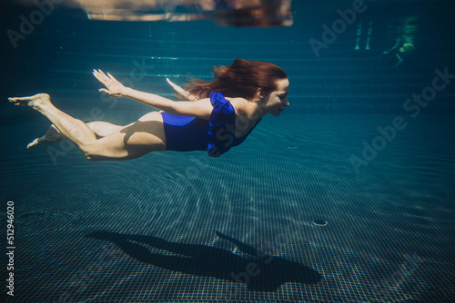 Young woman swimming underwater in the swimming pool © dsheremeta