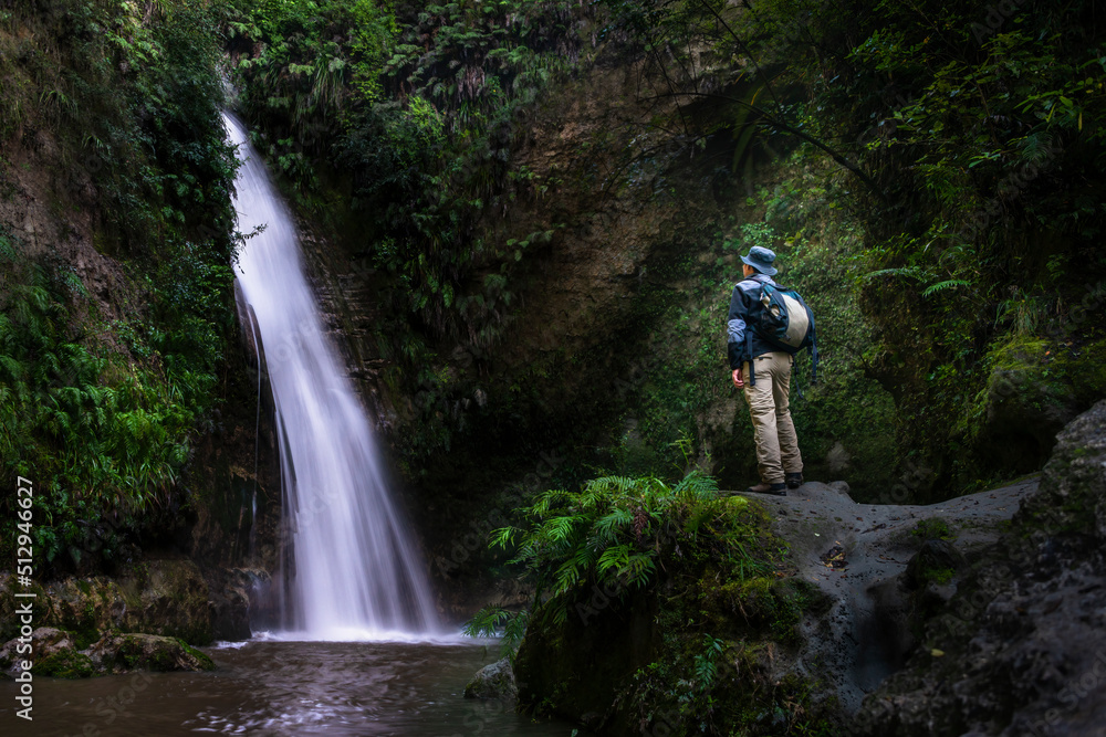Tourist admiring Te Ana waterfalls, Hawke’s Bay.
