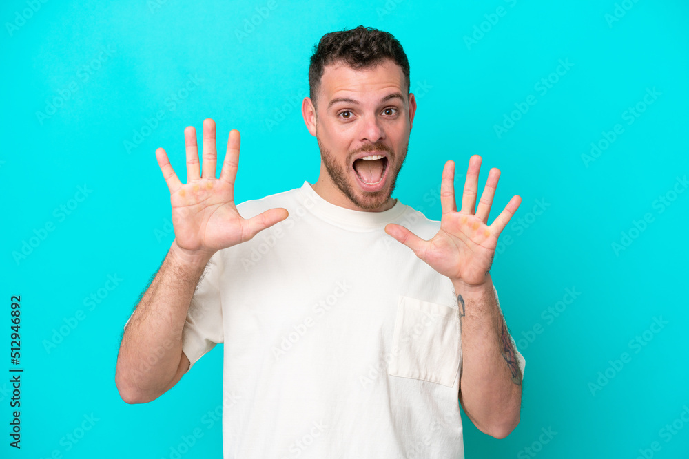 Young Brazilian man isolated on blue background counting ten with fingers Young Brazilian man isolated on blue background counting ten with fingers