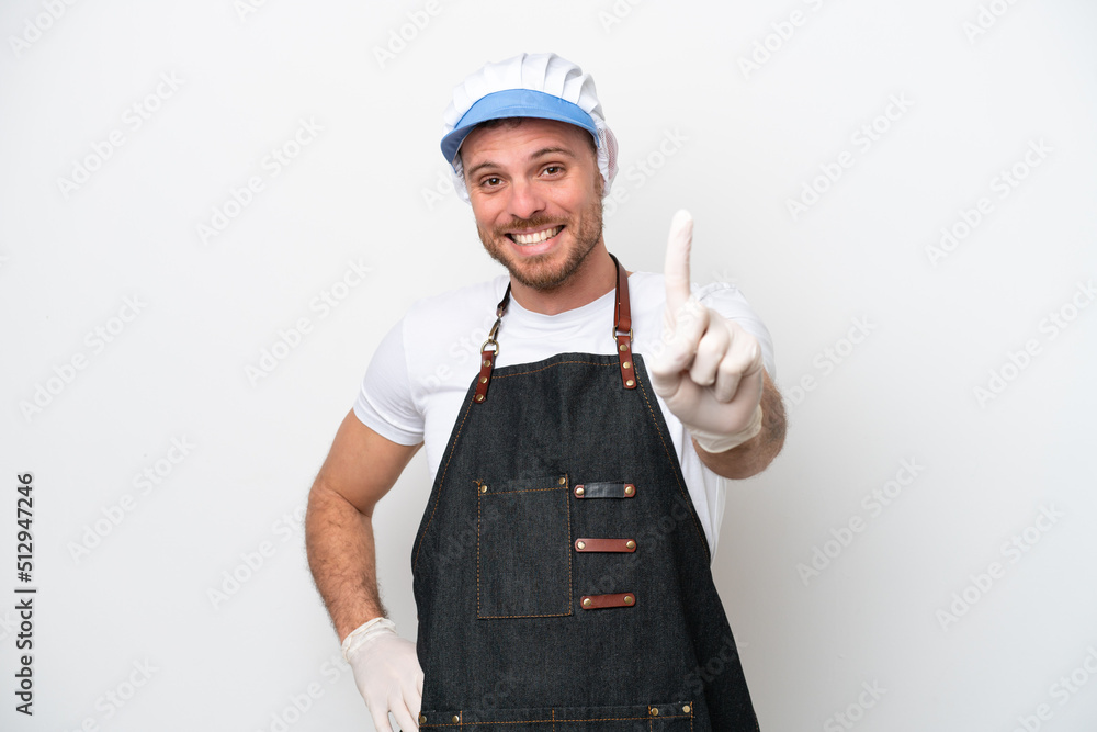 Fishmonger man wearing an apron isolated on white background showing and lifting a finger Fishmonger man wearing an apron isolated on white background showing and lifting a finger
