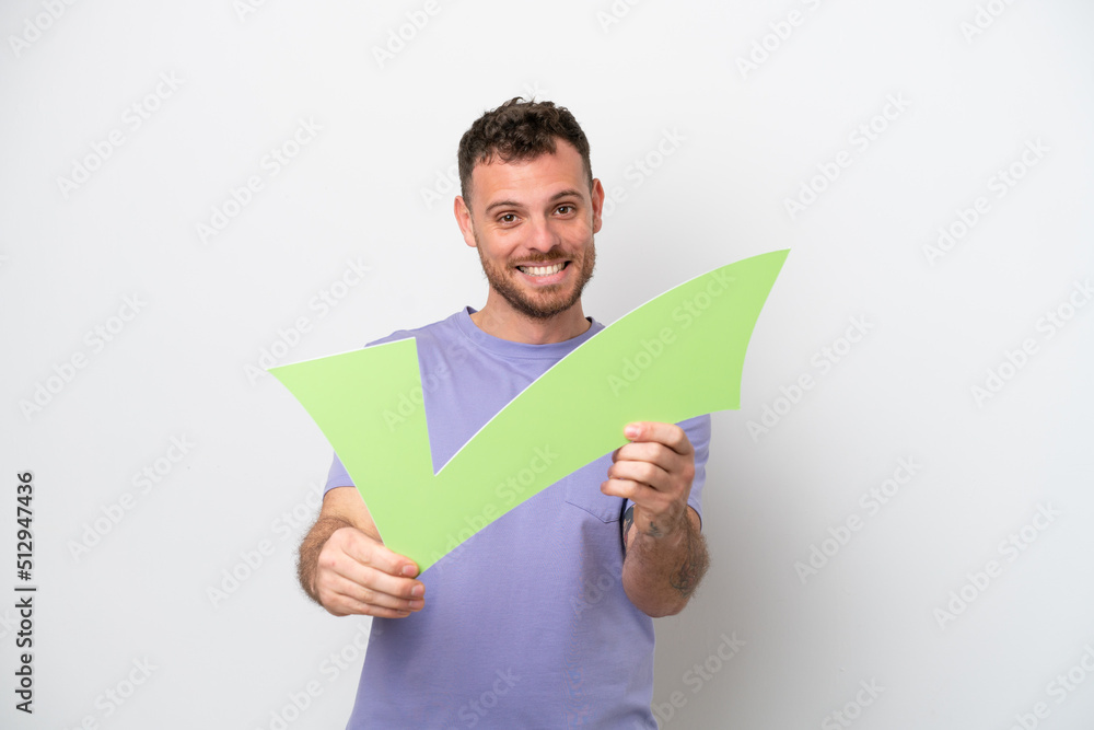 Young Brazilian man isolated on white background holding a check icon with happy expression Young Brazilian man isolated on white background holding a check icon with happy expression